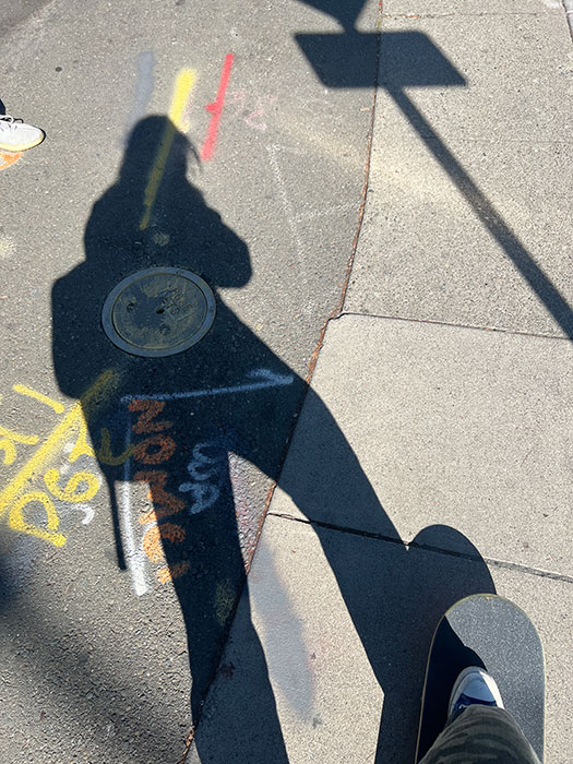 Photo of Dan Zhao shadow on the sidewalk