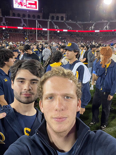 Eduardo Fatio takes a selfie on the field at a Berkeley Cal football game