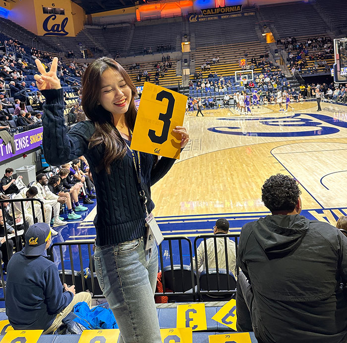 Jeongseo Kim and friend watch a Cal basketball game