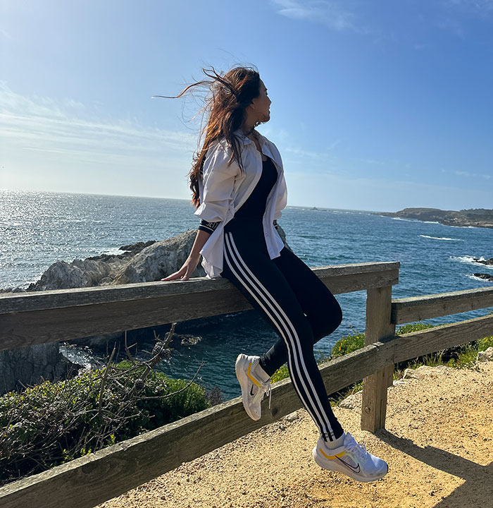 Jeongseo Kiim leaning against a wood railing at Big Sur