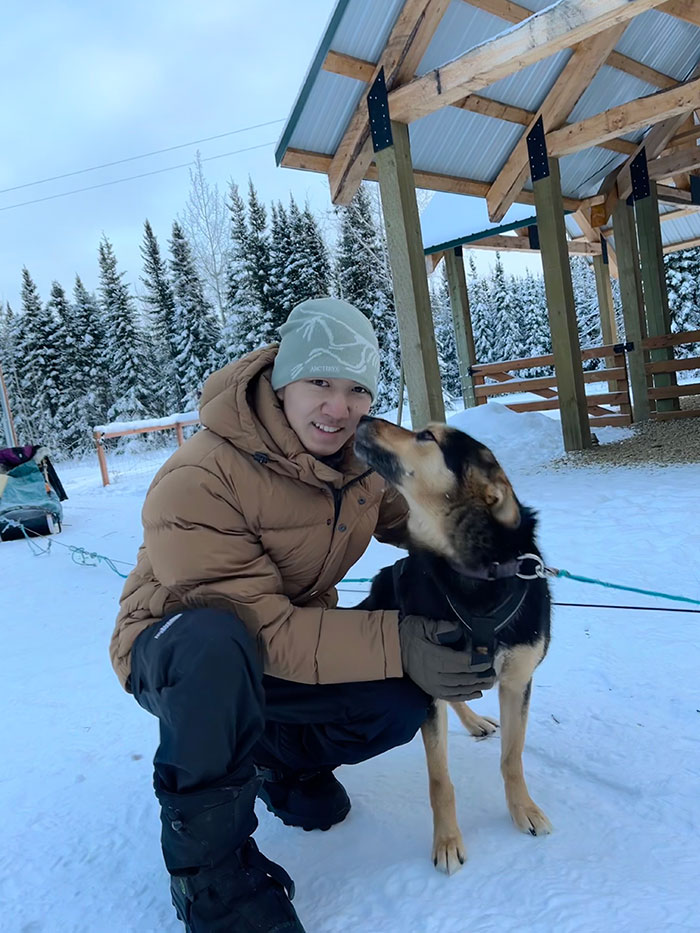 Keyang Pan and a dog outside of a ski lodge