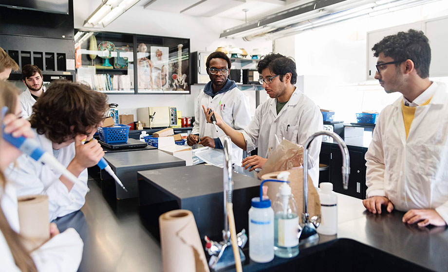 Group of college age diverse students working in a biology lab