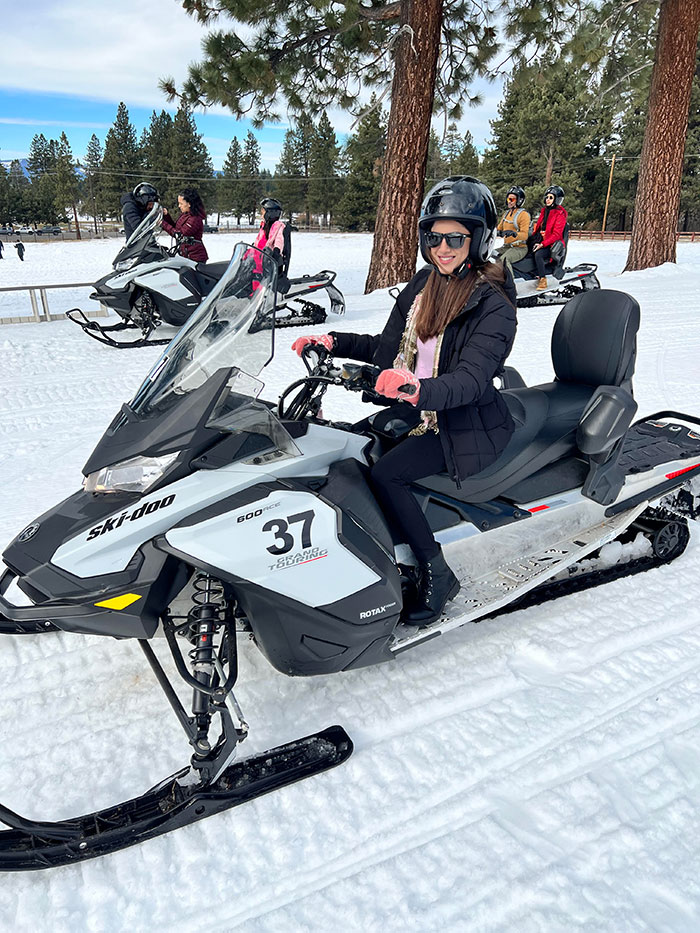 Meru Sharma sitting on top of a snowmobile