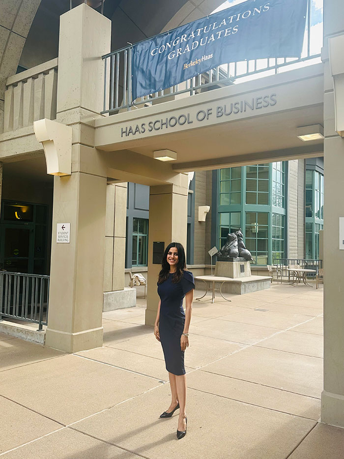 Meru Sharma standing below Berkeley Haas logo