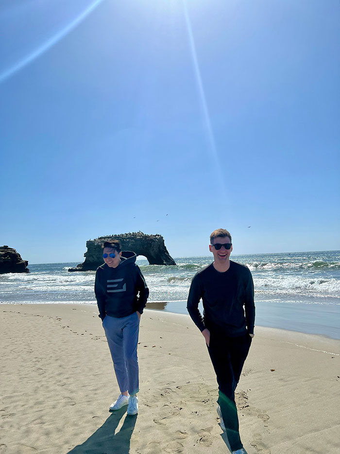 Michael Zhao and friend walking on San Francisco beach