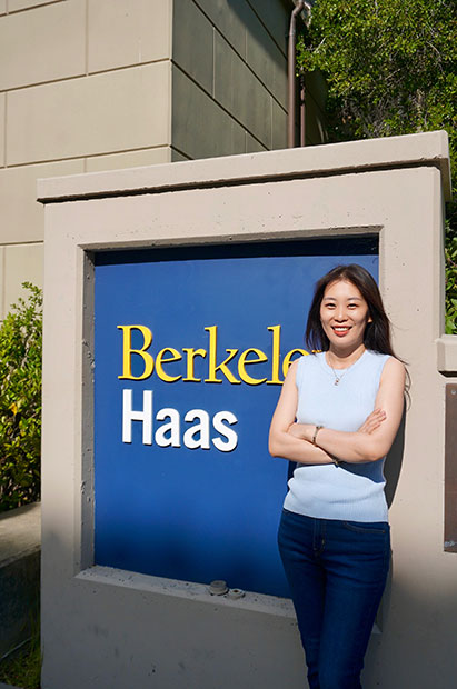 Yolanda Wang stands in front of Berkeley Haas sign
