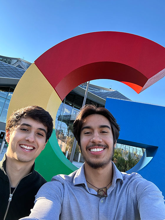 Arthur Oreb and friend take a selfie with Google logo in background
