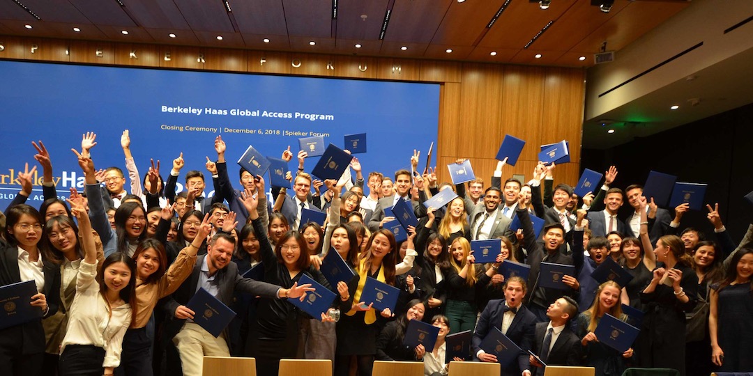 BHGAP international students throw their arms up in celebration during their closing ceremony photo.