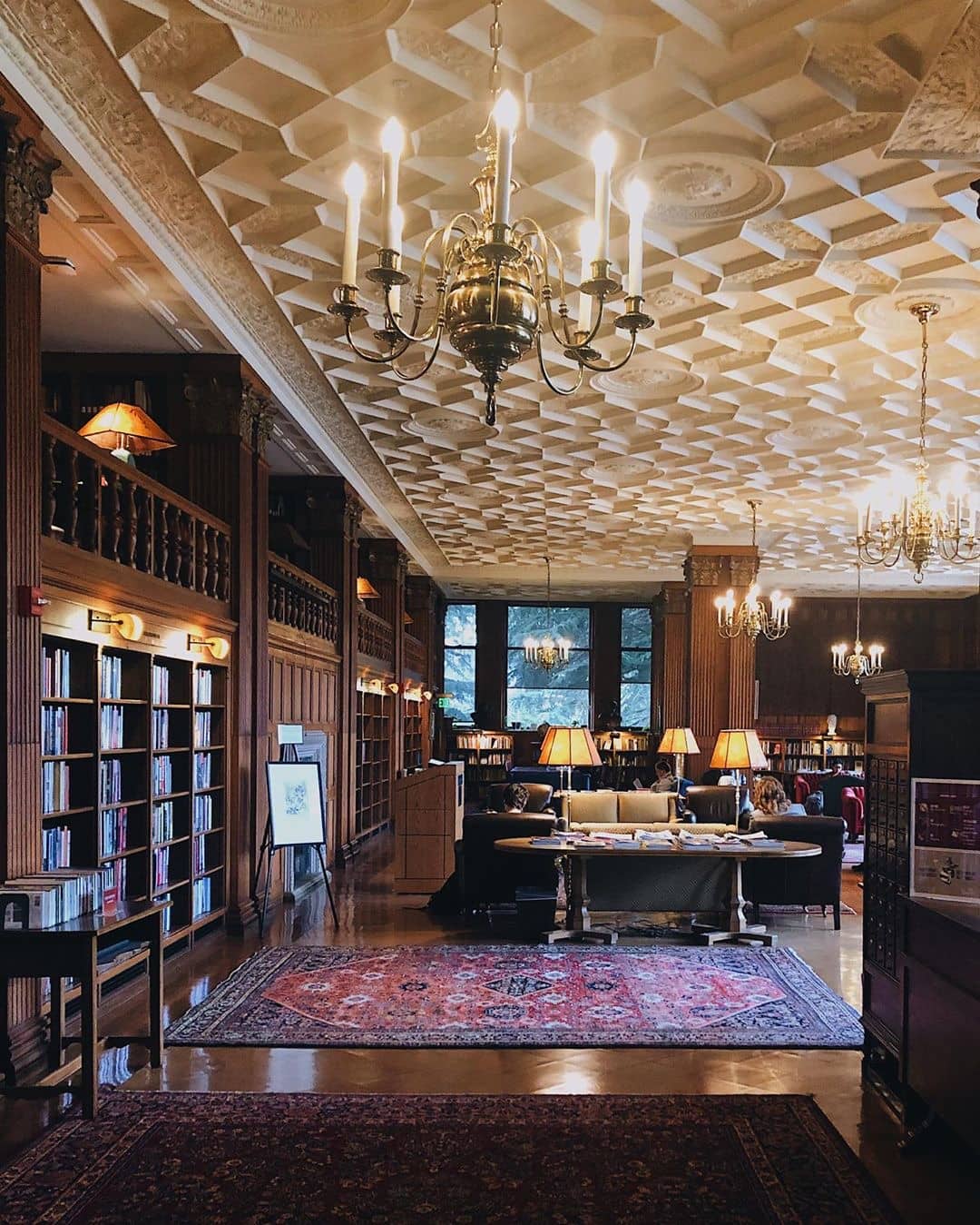 a beautiful campus library with carpets and chandeliers