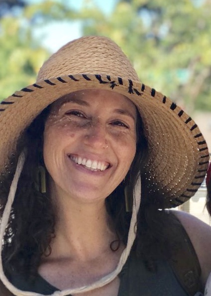 Dana Neufeld wearing a sun hat and smiling