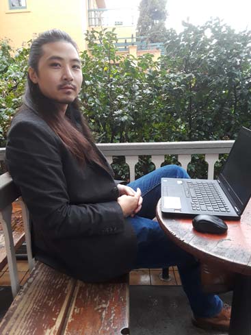 Medical writer Kevin Chen at his laptop