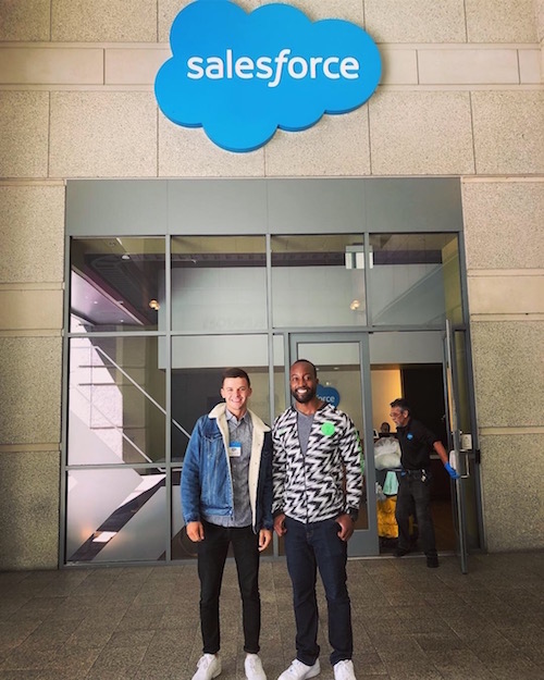 BHGAP student Marcel poses in front of the Salesforce sign