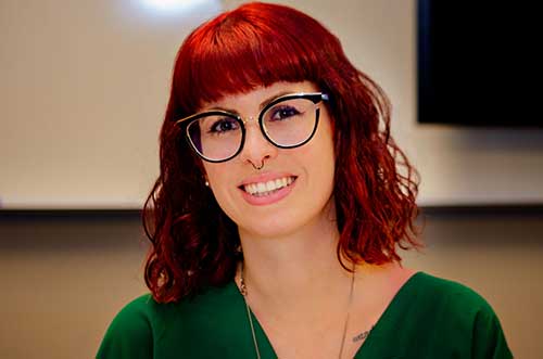 Panelist Thaisa Fernandes wearing a green shirt and eyeglasses