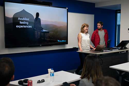 Students presenting their go-to-market strategy for Acubliss to the group