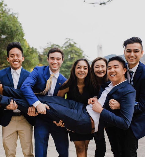 Rafael and his friends post in suits and dresses on the UC Berkeley campus.