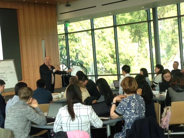 Photo of students sitting at a table in a class