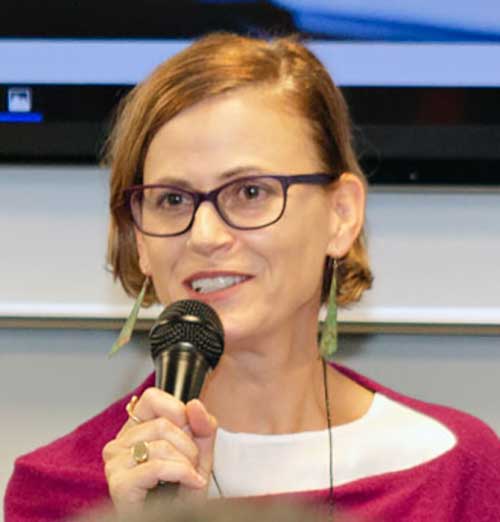 Lynne Von Bogdandy speaking into the microphone