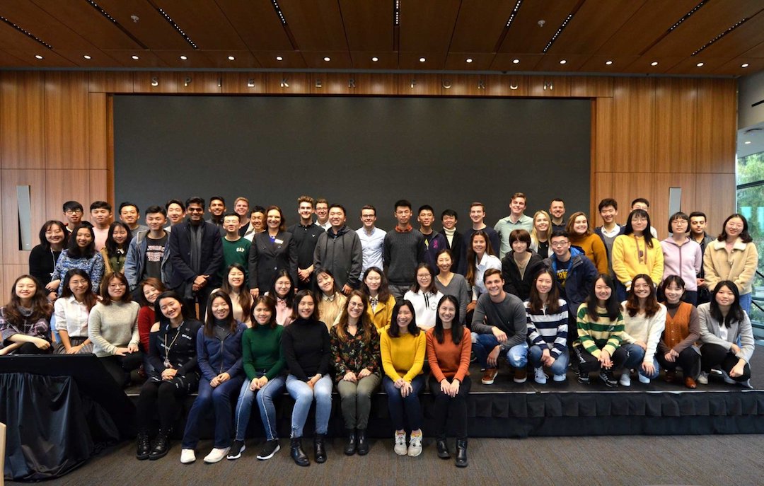 Markus and other students in the BHGAP program smiling for a group picture on a stage