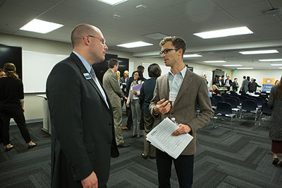 Photo of two attendees networking at event