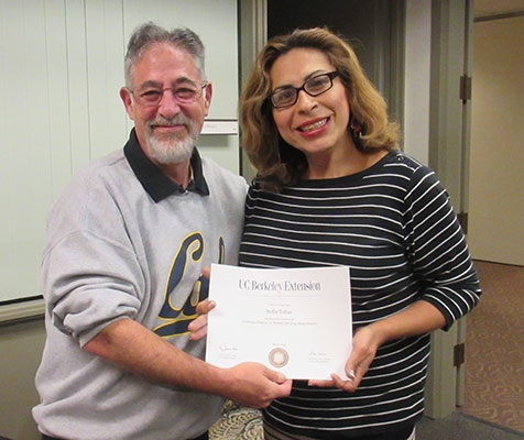 Program coordinator Jonathan Gill and student Sofia Tobar holding certificate