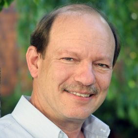 Headshot of instructor Richard Lehman smiling and wearing a button-up shirt