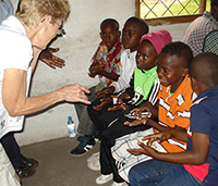 Stasi teaches ASL to deaf camp students in Africa