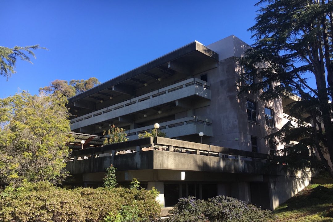 A view of Moffitt Library during the day, surrounded by trees