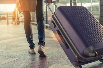 Photo of woman toting a suitcase at the airport