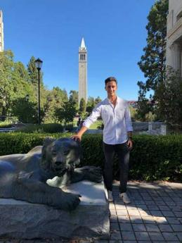 Photo of Alejandro Ruiz posing with UC Berkeley bear statue