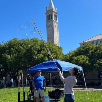 Lydia Bao catching bubbles on Berkeley campus as part of Homecoming festivities