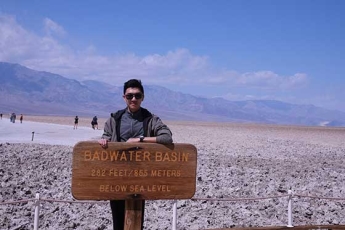 Keyang Pan standing in front of a sign that reads Badwater Basin
