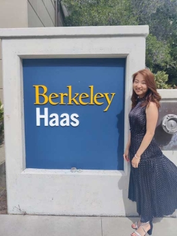 Rioko Enomoto standing in front of Haas School of Business sign