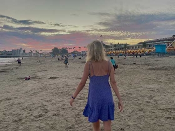 Hannah Boettge walking away from the camera at sunset at the Santa Cruz beach