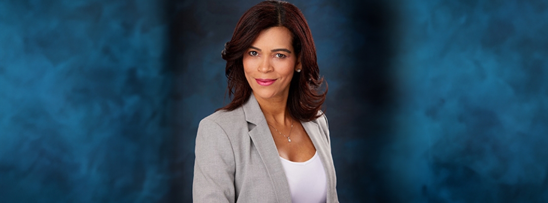 Headshot of Alis Vazquez in front of a blue background