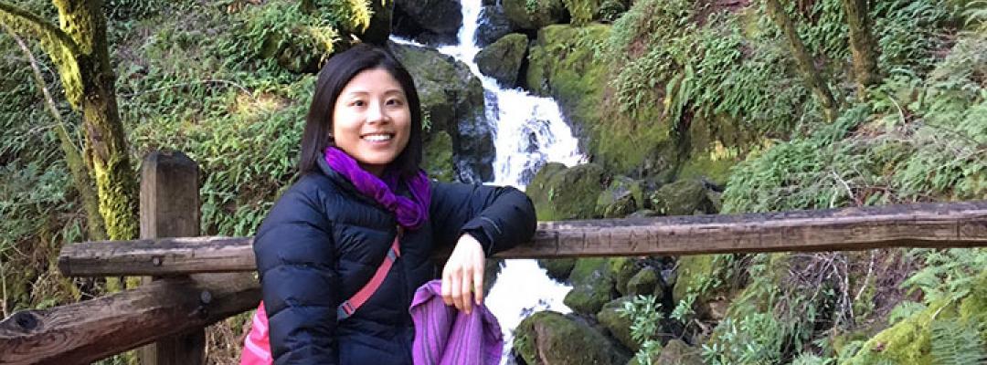 Interior designer Julia Chang posed in front of a waterfall