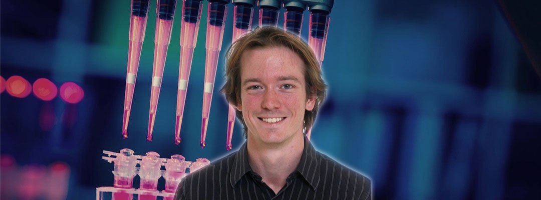 Post-Baccalaureate Health Professions Program alum Alexander Craig with lab stock photo background
