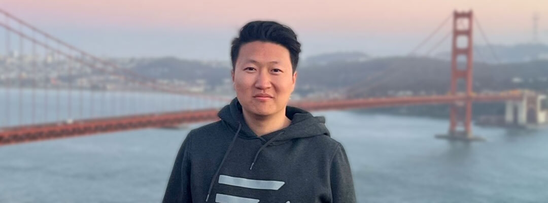 Photo of Michael Zhao standing in front of the Golden Gate Bridge