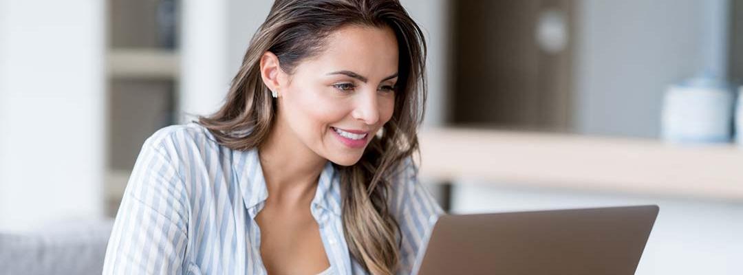 Photo of woman looking at laptop screen