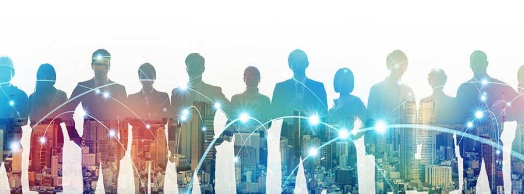 Scaled back image of multiple business people standing in front of a city skyline