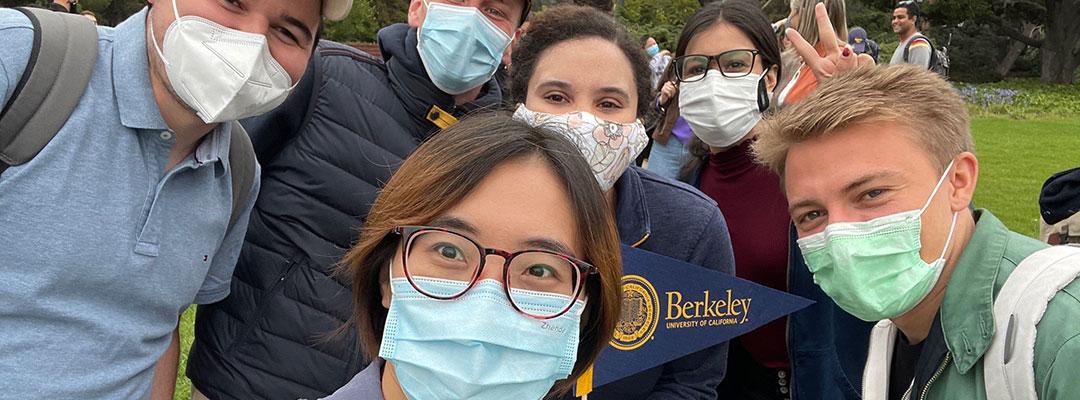 Group selfie of international students wearing masks on UC Berkeley campus 