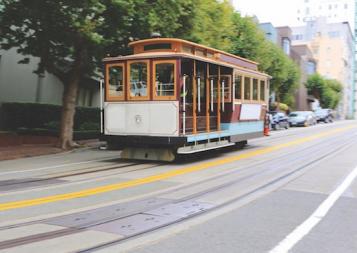 An iconic San Francisco cable car pictured on a city street.
