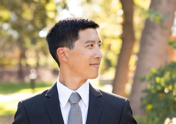 Certificate Program in Finance graduate Hosea Lin in a suit, looking off to the side