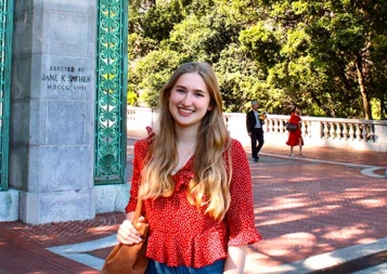 Lilly May standing in front of UC Berkeley Sather Gate