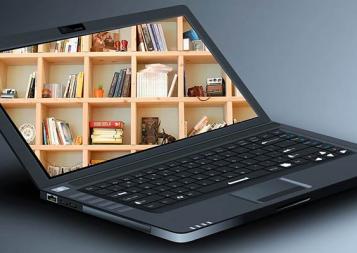 Stock photo of a black laptop open with a wooden bookcase filling the screen