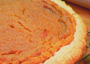 photo of a baked sweet potato pie resting on a cooling rack