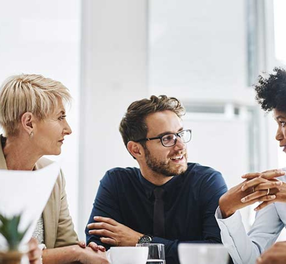 Photo of diverse group of professionals sitting at a table