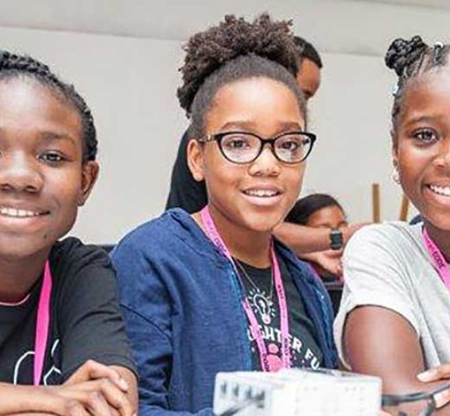 Image of three young black girls smiling at the camera