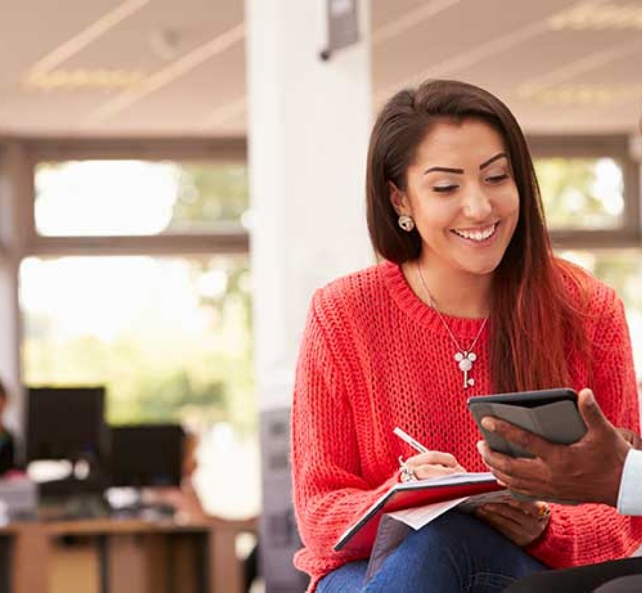 Photo of black college admissions adviser working with LatinX high school student