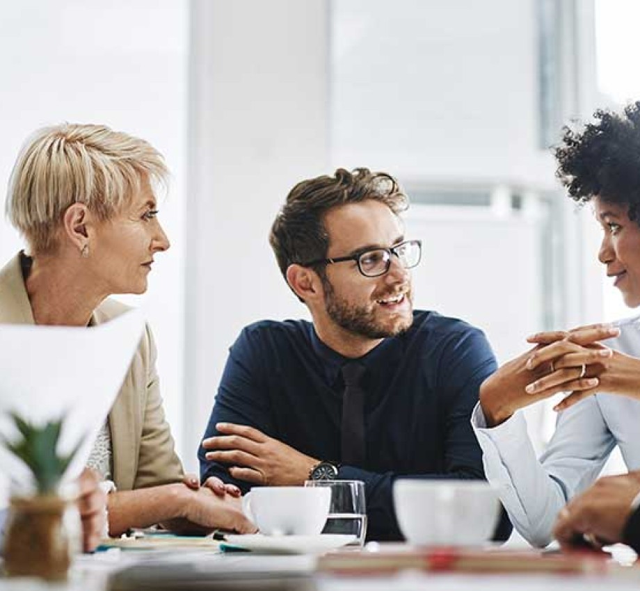 Photo of diverse group of professionals sitting at a table