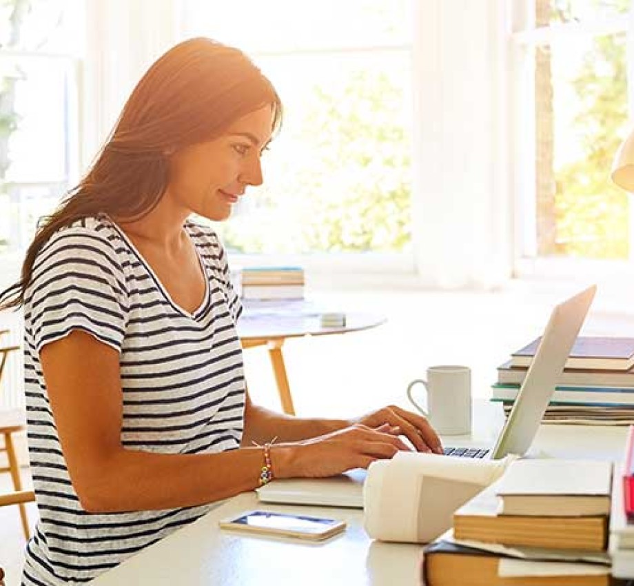 Woman typing on laptop in apartment room